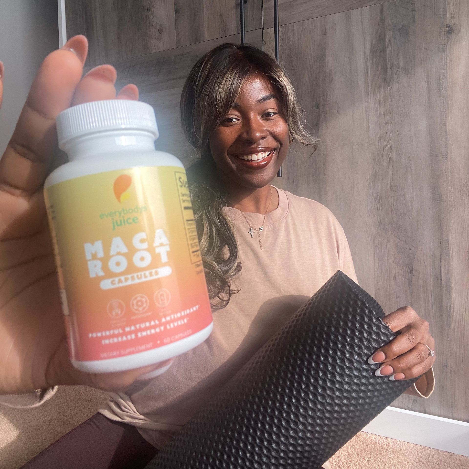 Woman holding Maca Root supplement bottle